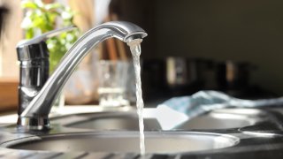 Water running from tap into kitchen sink