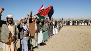 Houthi followers lift rifles and shout slogans against the U.S.-U.K. during a tribal gathering on January 14, 2024