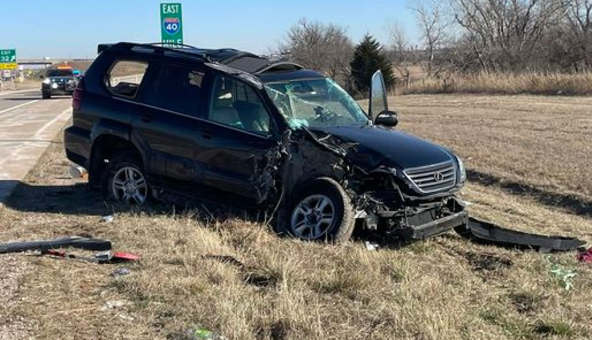 The mangled wreckage or the black SUV after the crash.