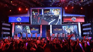 Visitors cheer for international teams during the tournament of the computer game ‘League of Legends’ on May 8, 2014 in Paris.