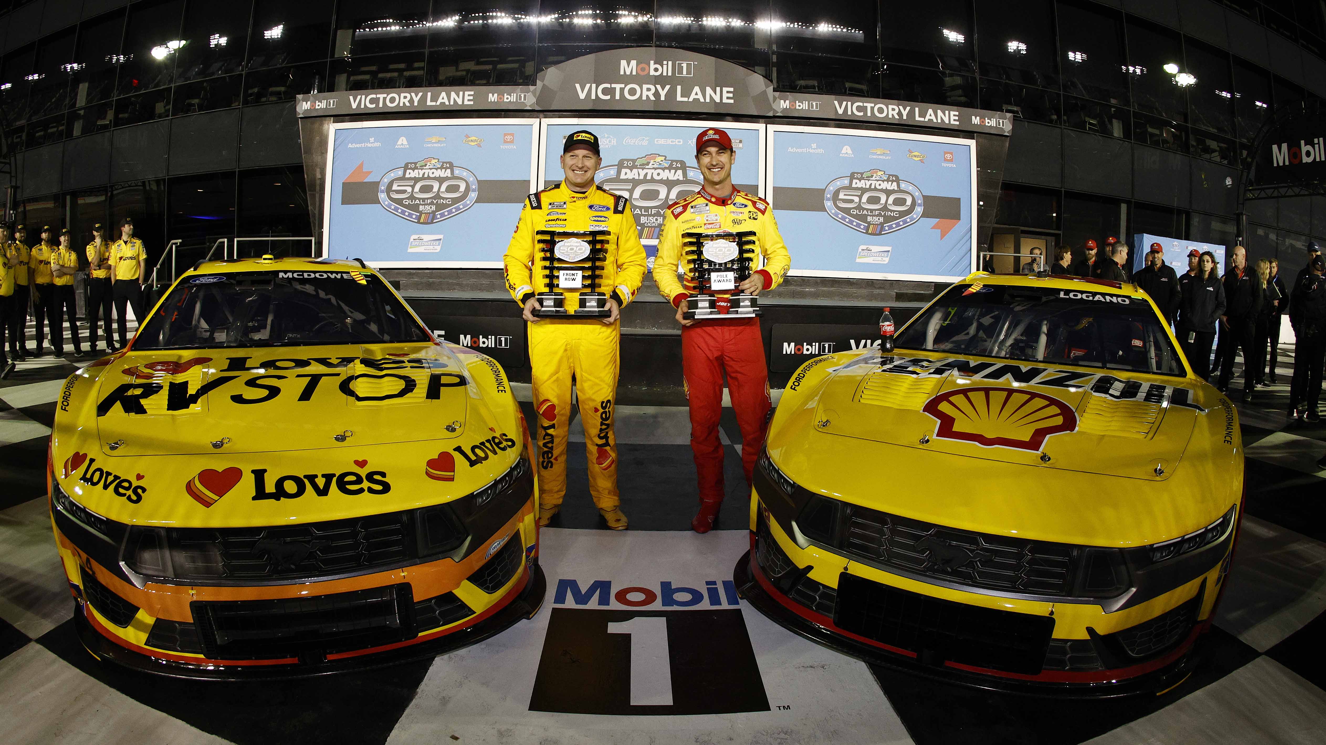 DAYTONA BEACH, FLORIDA - FEBRUARY 14: Joey Logano, driver of the #22 Shell Pennzoil Ford, (R) winner of the Daytona 500 pole award and Michael McDowell, driver of the #34 Love's Travel Stops Ford, Front Row second fastest winner pose for a photo during qualifying for the NASCAR Cup Series Daytona 500 at Daytona International Speedway on February 14, 2024 in Daytona Beach, Florida. (Photo by Sean Gardner/Getty Images)