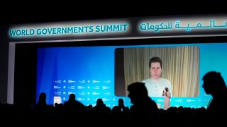 OpenAI CEO Sam Altman, seen on screen, talks on a video chat during the World Government Summit in Dubai.