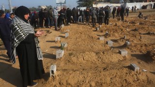 A Palestinian woman prays for a relative killed in the Israeli bombardment of the Gaza Strip in Khan Younis on Feb. 26, 2024.