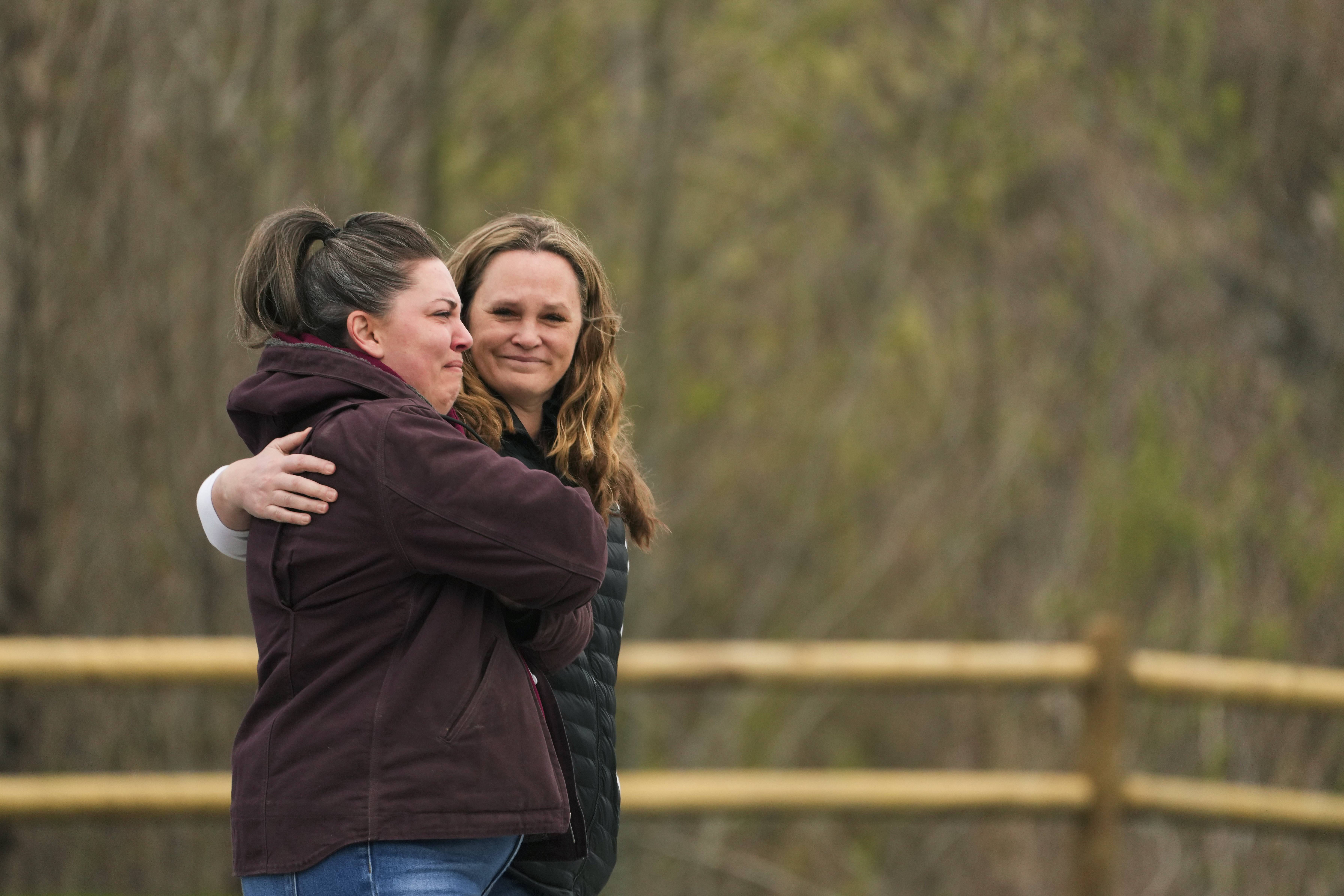 A woman comforts another as people arrive for the Oso Landslide Memorial dedication on the 10-year anniversary of the disaster, Friday, March 22, 2024, in Oso, Wash.