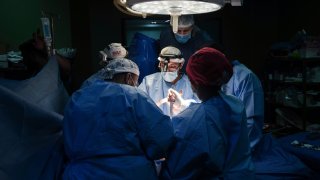 Doctors perform surgery on a patient at Al-Aqsa Martyrs Hospital, in Deir al-Balah, central Gaza.