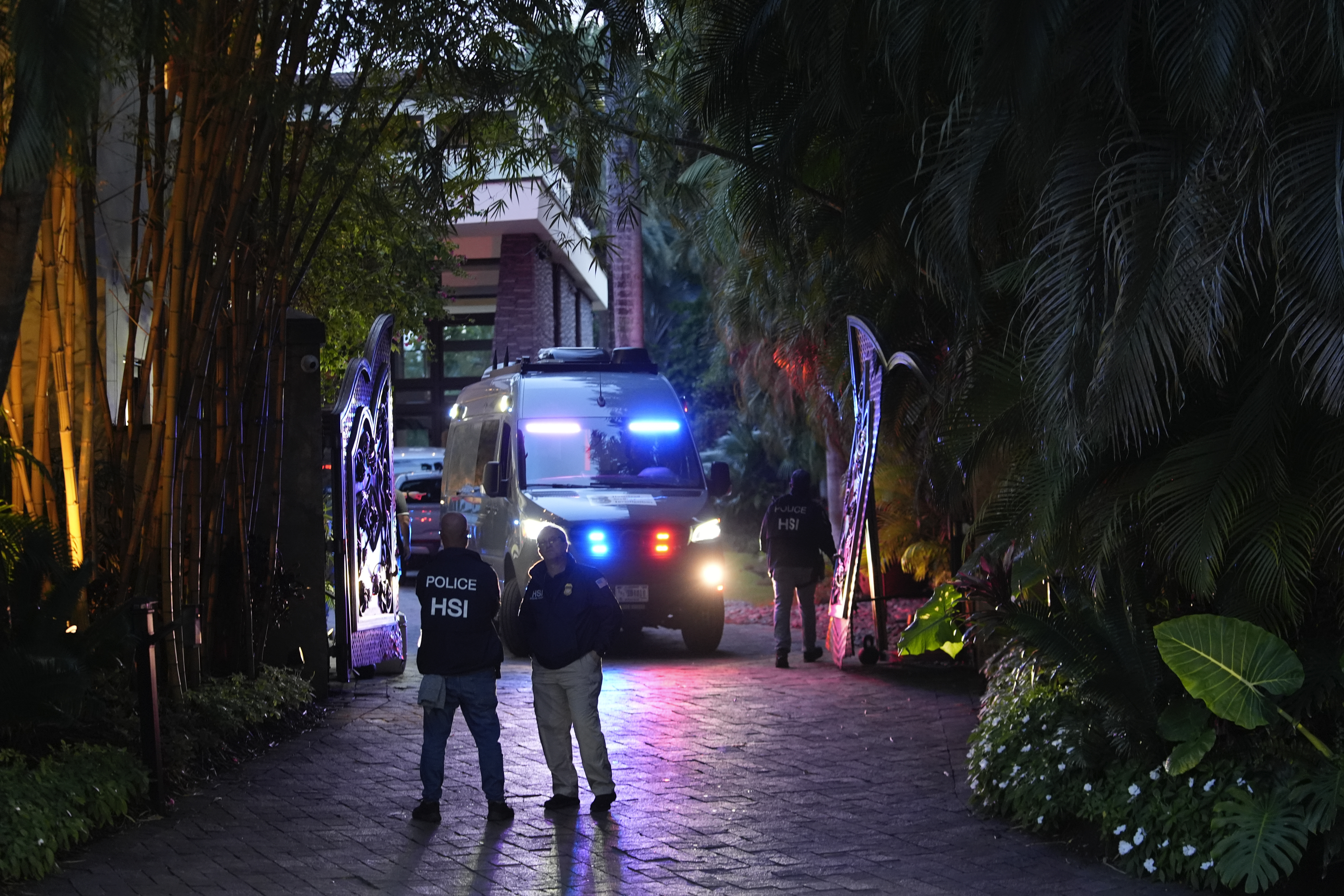 Federal agents stand at the entrance to a property belonging to rapper Sean "Diddy" Combs, Monday, March 25, 2024.