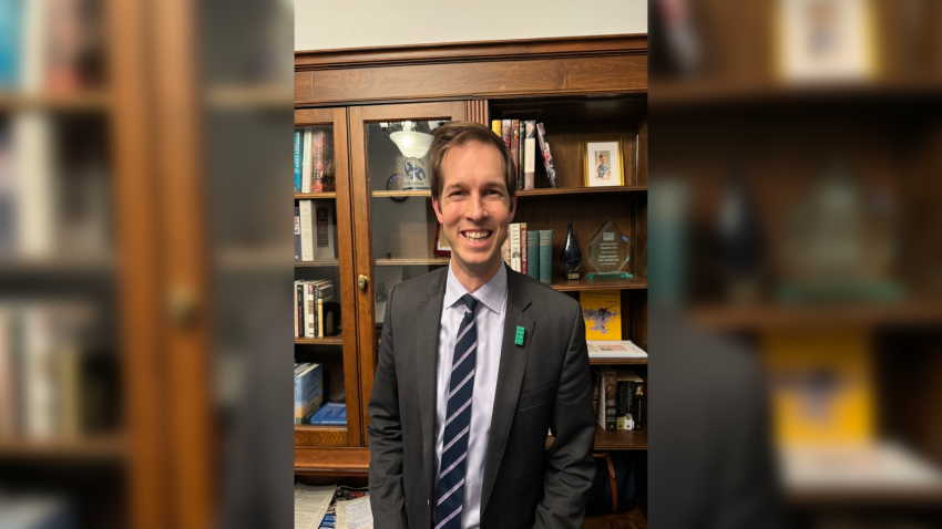 Rep. Jake Auchincloss displaying his Congressional Dads Caucus pin.