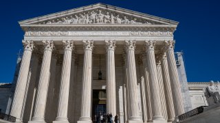 WASHINGTON, DC - FEBRUARY 29: Pedestrians walk in front of the U.S. Supreme Court February 29, 2024 in Washington, DC. The Supreme Court decided to take up former President Donald Trump's claim that he is immune from prosecution for actions he took in office. (Photo by Robert Nickelsberg/Getty Images)