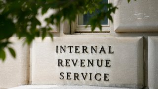 FILE - A sign outside the Internal Revenue Service building is seen, May 4, 2021, in Washington.