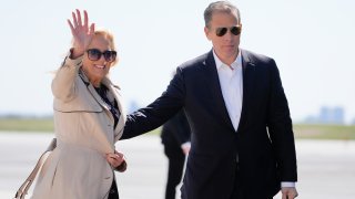 First lady Jill Biden waves as she walks with son Hunter Biden, to board Air Force One at John F. Kennedy International Airport
