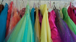 Pretty prom dresses ready for young shoppers crowd the rack.