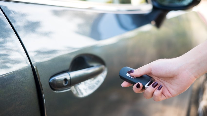 Close up woman hand opening car door.