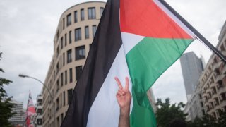 A protester waves a Palestinian flag during a Pro-Palestine demonstration held in Berlin, Germany, on May 18, 2024.