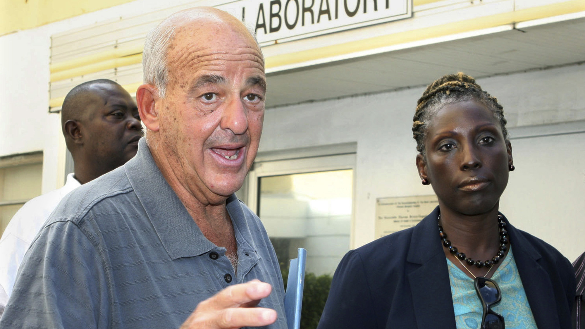 FILE - Pathologist Dr. Cyril Wecht, center, talks to the media while Bahamas' head coroner Linda Virgil, right, and attorney Michael Scott, left, listen outside the Rand Laboratory morgue at the Princess Margaret Hospital in Nassau, Bahamas, Sept. 17, 2006. 