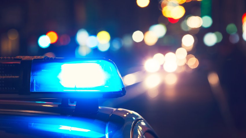 Blue flasher on the police car at night