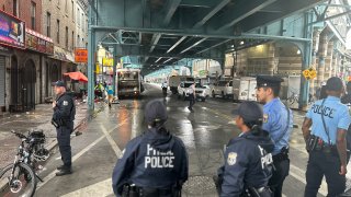 Police look up a cleared out Kensington Avenue.