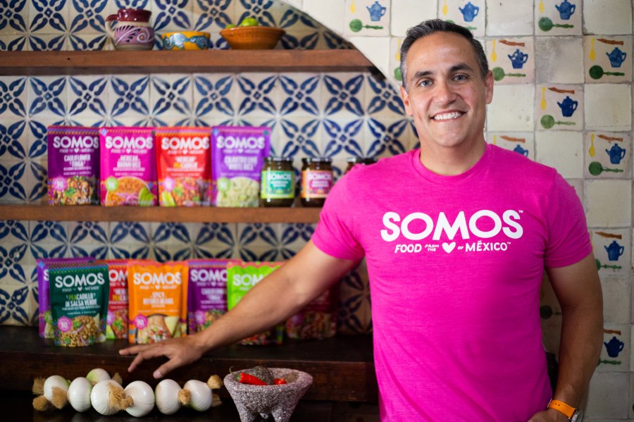 Miguel Leal in front of a variety of SOMOS products