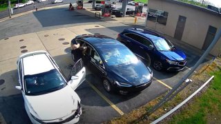 A surveillance image shared by police shows an incident in which, officials said, $190,000 was stolen from a car parked at a gas station in Bensalem.