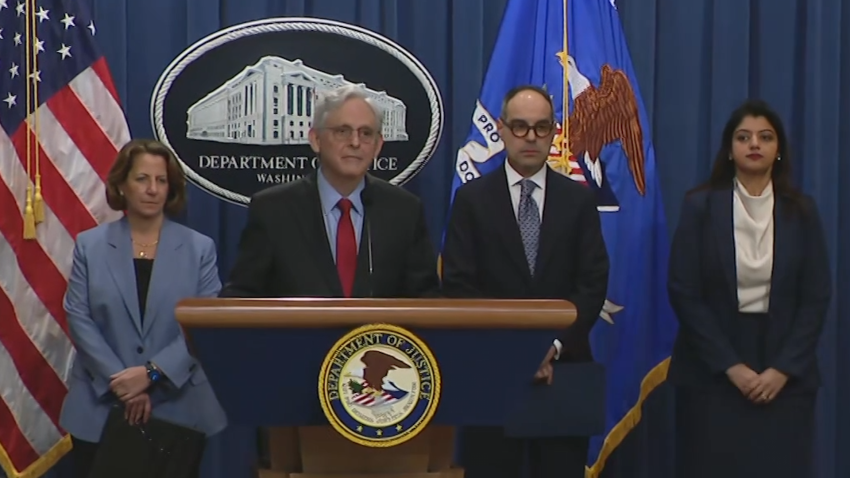 Attorney General Merrick Garland with DOJ representatives during press conference.