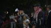 Hundreds of people protest in University City on Friday night carrying Palestinian flags
