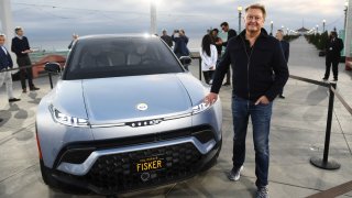 Henrik Fisker stands with the Fisker Ocean electric vehicle after its unveiling at the Manhattan Beach Pier ahead of the Los Angeles Auto Show and AutoMobilityLA in Manhattan Beach, California. on Nov. 16, 2021.