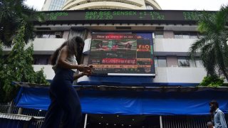 A woman walks past Bombay Stock Exchange (BSE) office in Mumbai, India, 18 July, 2022.