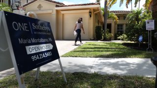 A potential buyer walks in to view a home for sale during an open house in Parkland, Florida, May 25, 2021.