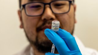 Pharmacist Aaron Sun prepares Pfizer’s new Covid vaccine Comirnaty at CVS Pharmacy in Eagle Rock, California.