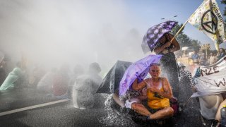 The police use water cannon against climate activists of “Extinction Rebellion” movement, who block the Utrechtsebaan on the A12 road, during a protest in The Hague, on September 9, 2023.