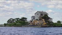 An abandoned mansion on a remote island at the Jersey Shore is being demolished