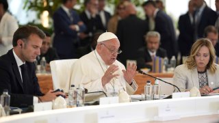 From left, French President Emmanuel Macron, left, and Italy’s Prime Minister Giorgia Meloni, right, listen to Pope Francis speaking during a working session on Artificial Intelligence (AI), Energy, Africa-Mediterranean, on day two of the 50th G7 summit at Borgo Egnazia, southern Italy, on Friday, June 14, 2024.