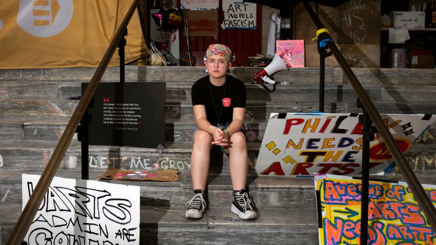 Rising sophomore Cyrus Nasib, 18, sits on the steps of Dorrance Hamilton Hall at the University of the Arts, Friday, June 14, 2024, in Philadelphia.  Students at the university were thrown into panic mode two weeks ago, as they got the startling news that their school would be shutting down within days. The increase in closures of more colleges around the country in recent years has left tens of thousands of students in limbo — and at increased risk of never finishing their degrees at all.