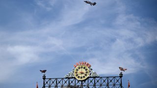A fighter jet, as part of Maryland Fleet Week and Flyover festivities, flies by Oriole Park at Camden Yards during a baseball game between the Baltimore Orioles and the Philadelphia Phillies, Sunday, June 16, 2024, in Baltimore.