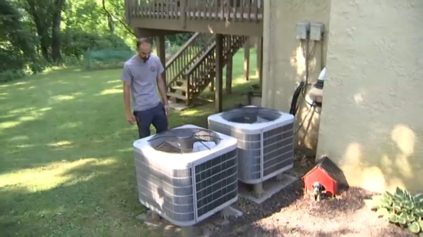 Paul Karalis looks at air conditioning units