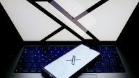 The X logo is shown on a laptop screen and phone screen.