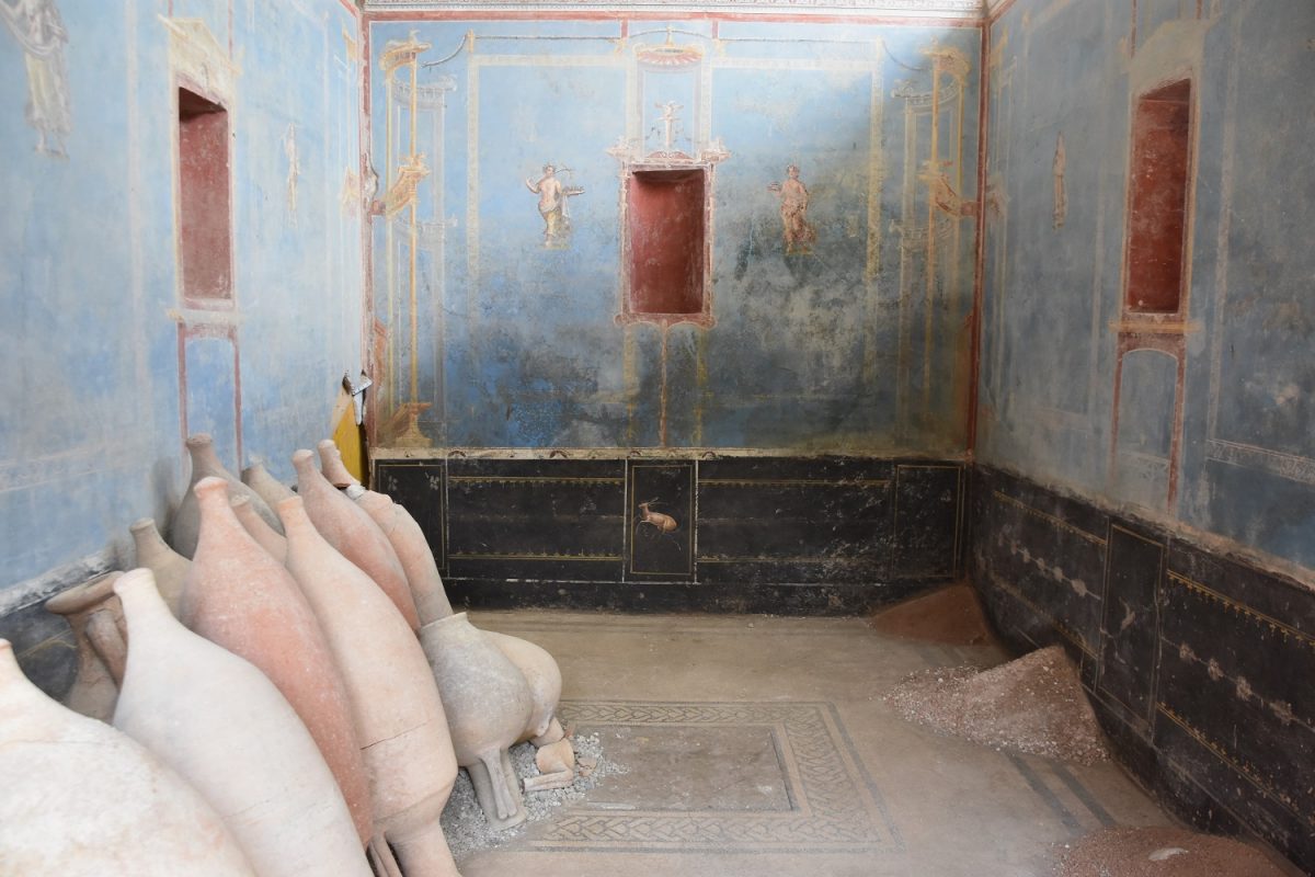 A rare blue room discovered in Pompeii with transport amphorae, left, and a pile of already worn oyster shells on the threshold of the entrance, which were probably added to plaster and mortar mixes once they had been ground up.