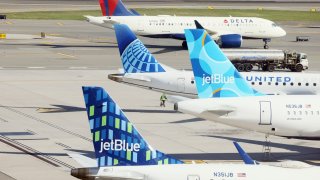 Airplanes from United and JetBlue and Delta populate the taxiway at Laguardia Airport in the Queens borough of New York City. 