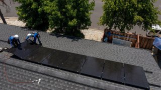 Workers install solar panels during a SunPower installation on a home in Napa, California, US, on Monday, July 17, 2023. 