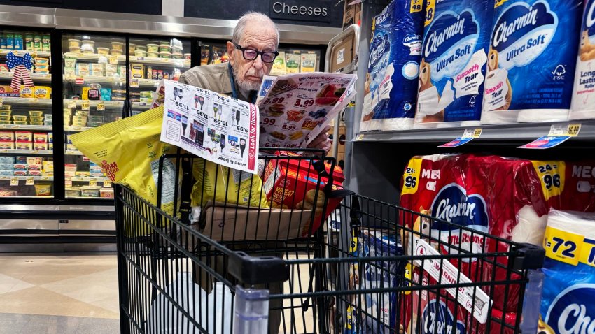 A shopper scans coupons in a grocery store in Washington, D.C., on May 23, 2024. 