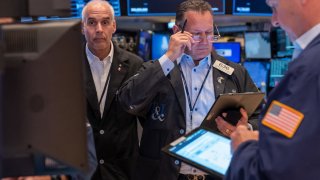 Traders work on the floor of the New York Stock Exchange on June 18, 2024.