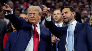 Republican presidential nominee and former U.S. President Donald Trump and Republican vice presidential nominee J.D. Vance point to the stage during Day 1 of the Republican National Convention (RNC), at the Fiserv Forum in Milwaukee, Wisconsin, U.S., July 15, 2024. 