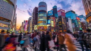 Chuo Ward, Tokyo, Japan – February 23, 2018; Top luxury shopping streets with multi colored neon signs. Ginza avenues are lined with shops of expensive brands and restaurants in the heart of Tokyo. It is half past five p.m. on Friday. People flock to Ginza for shopping, dinner and drinking with their friends. Ginza became synonymous with major shopping districts in Japan.