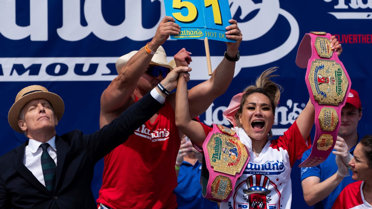 Dental hygienist scarfs down 51 hot dogs to win her 10th eating contest, set world record