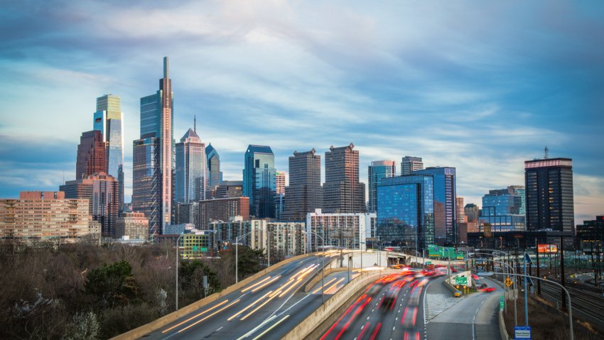 A skyline shot of Philadelphia taken at dusk. It was a peaceful and warm spring evening with the traffic of light streaks zooming through.