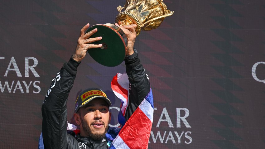 Lewis Hamilton of Great Britain and Mercedes-AMG PETRONAS F1 Team celebrates his win on the podium during the F1 Grand Prix of Great Britain at Silverstone Circuit on July 7, 2024 in Northampton,