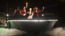 Spain's tennis player Rafael Nadal (2L), holds the Olympic flame, flanked by US former runner Carl Lewis, Romanian former gymnast Nadia Comenci and US tennis player Serena Williams on a speedboat during a torch relay departing from Iena bridge towards the Tuileries Gardens along the river Seine during the opening ceremony of the Paris 2024 Olympic Games in Paris on July 26, 2024. (Photo by Philippe Lopez / AFP) (Photo by PHILIPPE LOPEZ/AFP via Getty Images)