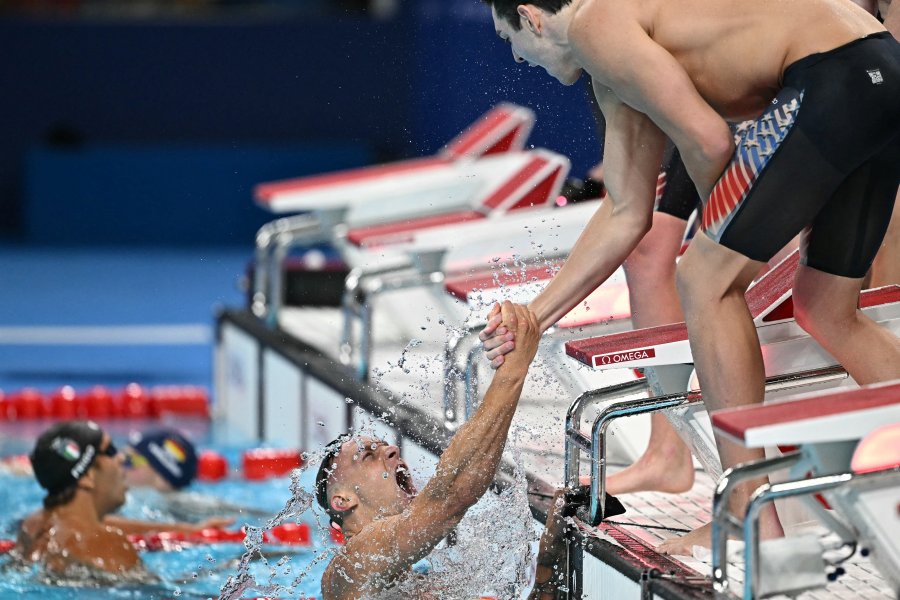 Gold medallists US' Caeleb Dressel, US' Hunter Armstrong, US' Chris Guiliano and US' Jack Alexy celebrate following the final of the men's 4x100m freestyle relay swimming event