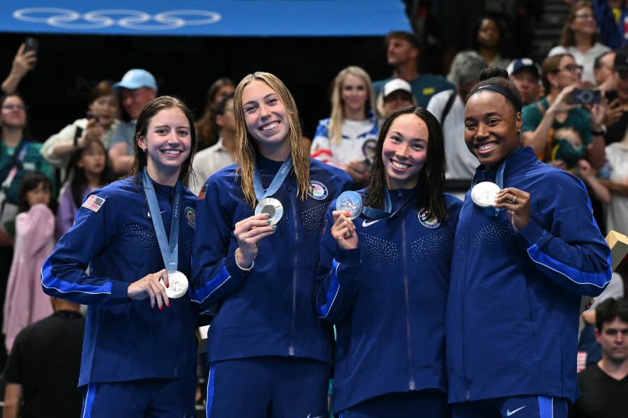 Silver medallists US' Kate Douglass, US' Gretchen Walsh, US' Torri Huske and US' Simone Manuel pose with their medals