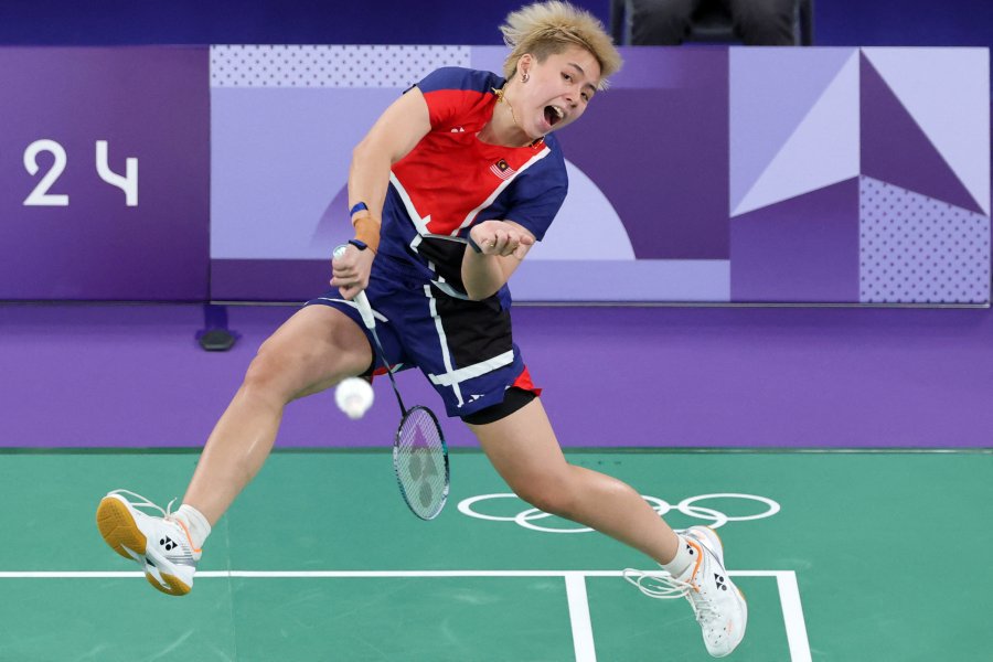 Malaysia's Toh Ee Wei plays a shot in the mixed doubles badminton group stage match against China during the Paris 2024 Olympic Games at Porte de la Chapelle Arena in Paris.