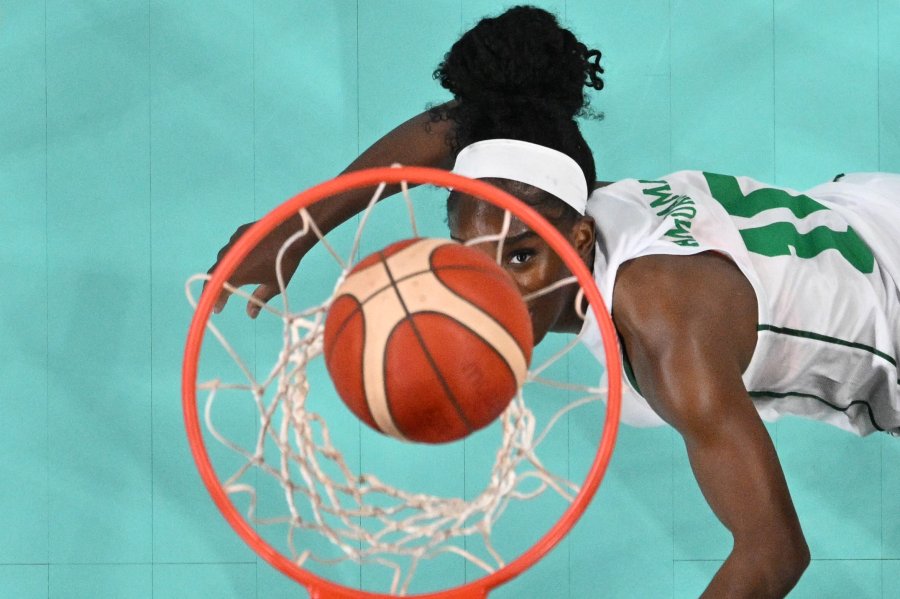 An overview shows Nigeria's #10 Promise Amukamara falling as she scores